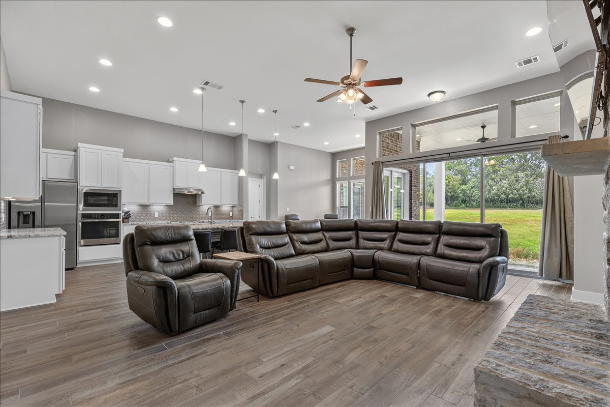 320 Raptor Beak Way Cedar Creek, TX 78612 - Photo 13 of 40 An open-concept living space with a contemporary kitchen and serene backyard views.