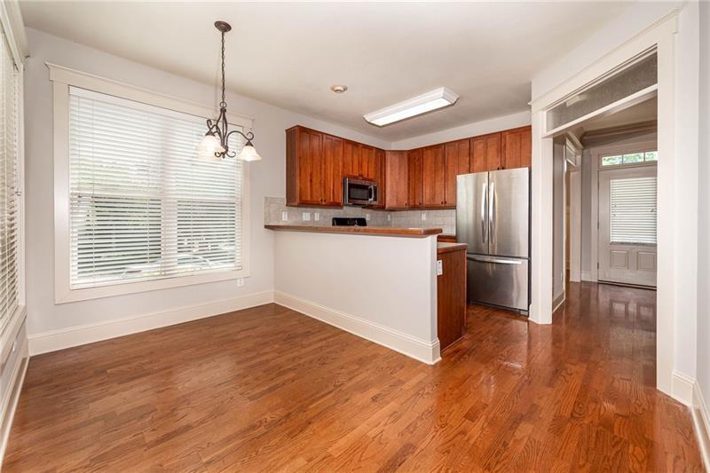 65 Orchard Drive Covington, GA 30014 - Photo 11 of 50 a kitchen with stainless steel appliances a refrigerator sink and wooden floor