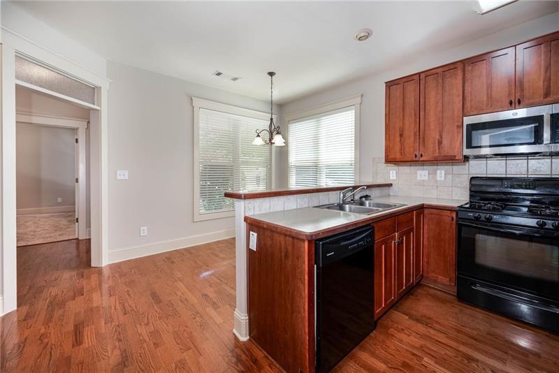 65 Orchard Drive Covington, GA 30014 - Photo 13 of 50 a kitchen with stainless steel appliances granite countertop a stove and a sink