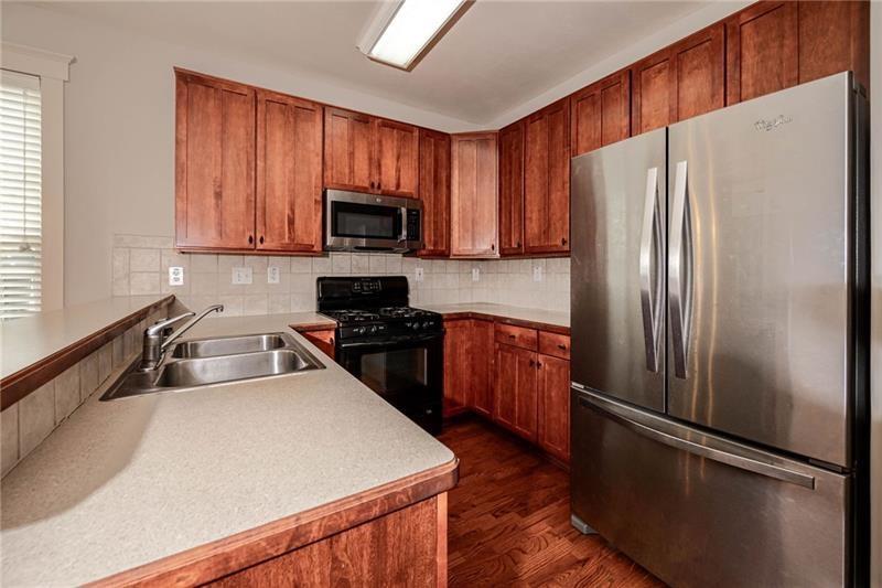65 Orchard Drive Covington, GA 30014 - Photo 14 of 50 a kitchen with a refrigerator sink and microwave