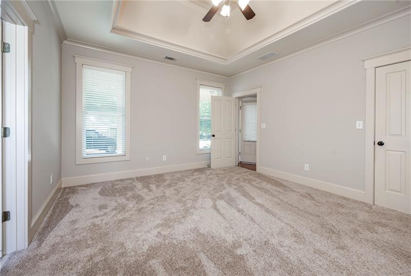65 Orchard Drive Covington, GA 30014 - Photo 18 of 50 a view of an empty room with a window and a ceiling fan