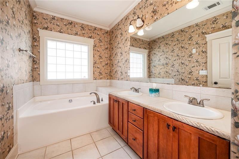 65 Orchard Drive Covington, GA 30014 - Photo 20 of 50 a spacious bathroom with a tub sink and mirror