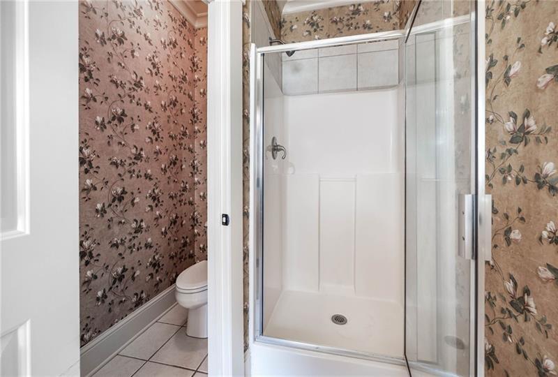 65 Orchard Drive Covington, GA 30014 - Photo 21 of 50 a bathroom with a toilet and a shower