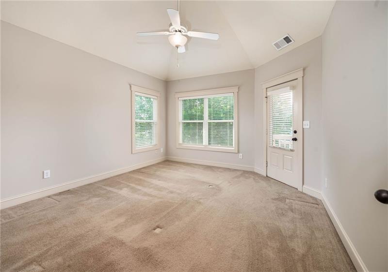 65 Orchard Drive Covington, GA 30014 - Photo 22 of 50 an empty room with windows and ceiling fan