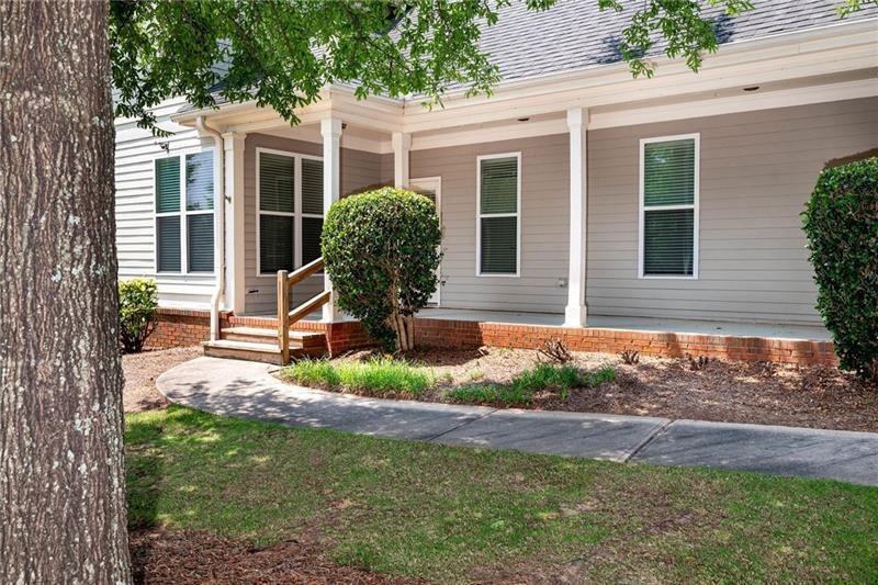 65 Orchard Drive Covington, GA 30014 - Photo 37 of 50 a front view of a house with garden