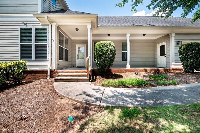 65 Orchard Drive Covington, GA 30014 - Photo 38 of 50 a front view of a house with garden