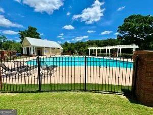 65 Orchard Drive Covington, GA 30014 - Photo 44 of 50 a view of a house with a yard and a garden