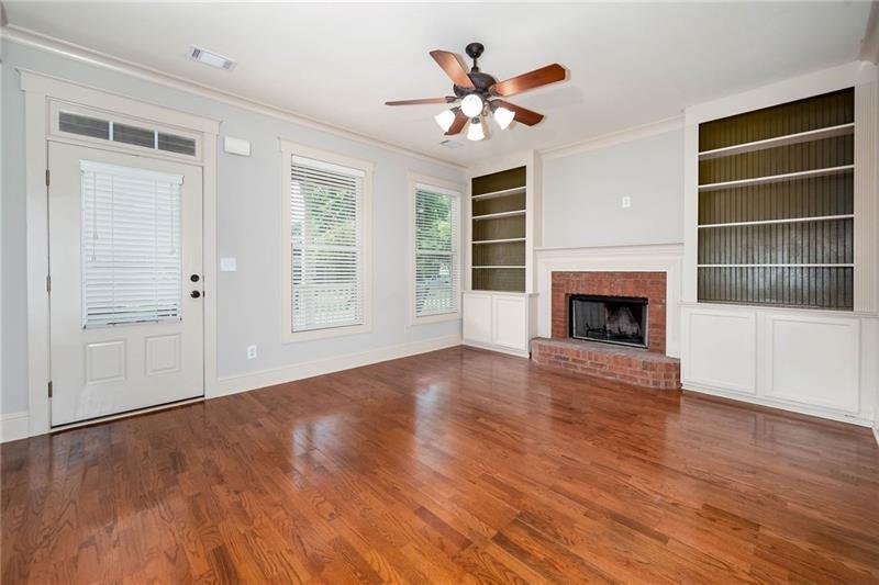 65 Orchard Drive Covington, GA 30014 - Photo 7 of 50 a view of an empty room with wooden floor and a window