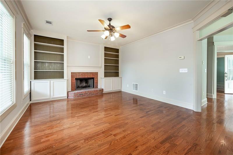 65 Orchard Drive Covington, GA 30014 - Photo 10 of 50 an empty room with wooden floor fireplace and window