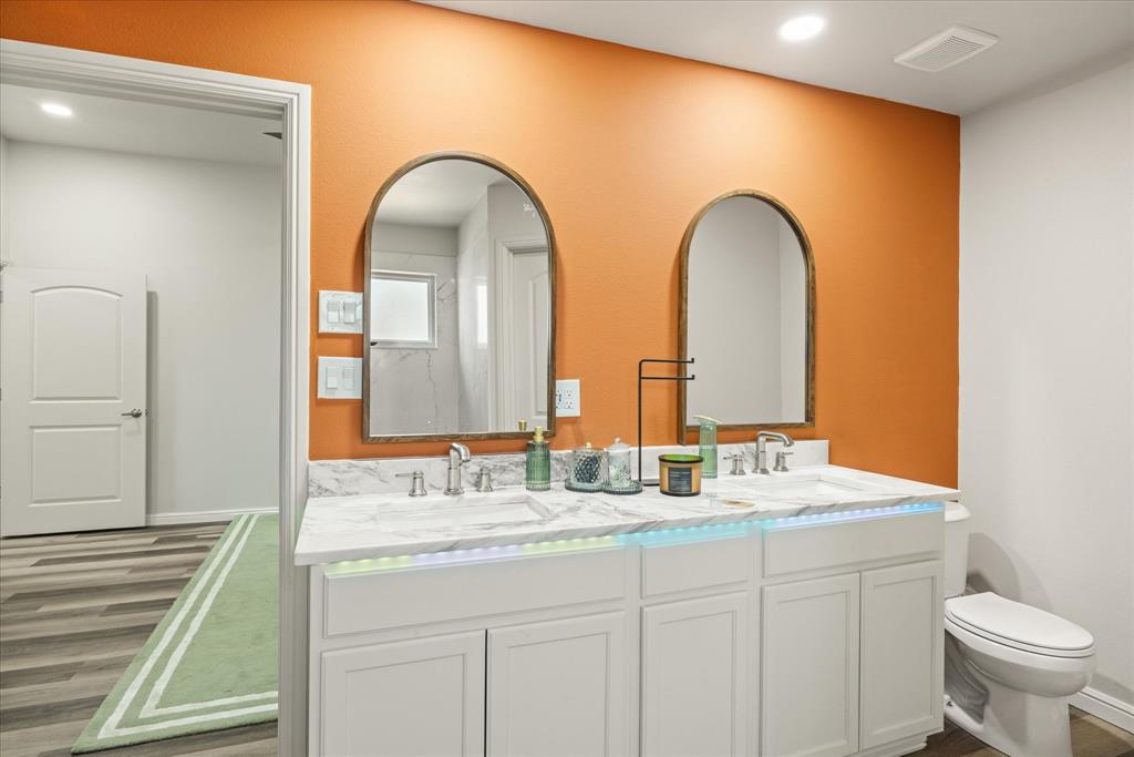 4801 West Wedgefield Road Granbury, TX 76049 - Photo 17 of 40 a bathroom with a double vanity sink and a mirror