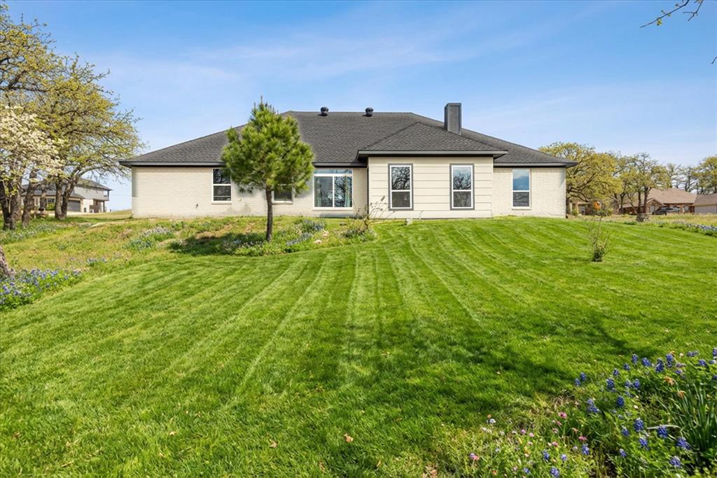 4801 West Wedgefield Road Granbury, TX 76049 - Photo 2 of 40 a front view of a house with a yard