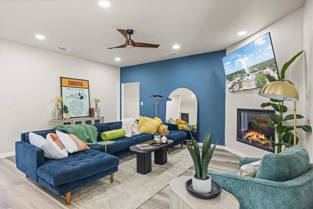4801 West Wedgefield Road Granbury, TX 76049 - Photo 21 of 40 a living room with fireplace furniture and a potted plant