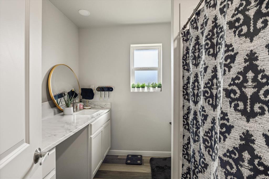 4801 West Wedgefield Road Granbury, TX 76049 - Photo 24 of 40 a kitchen with a sink and a stove