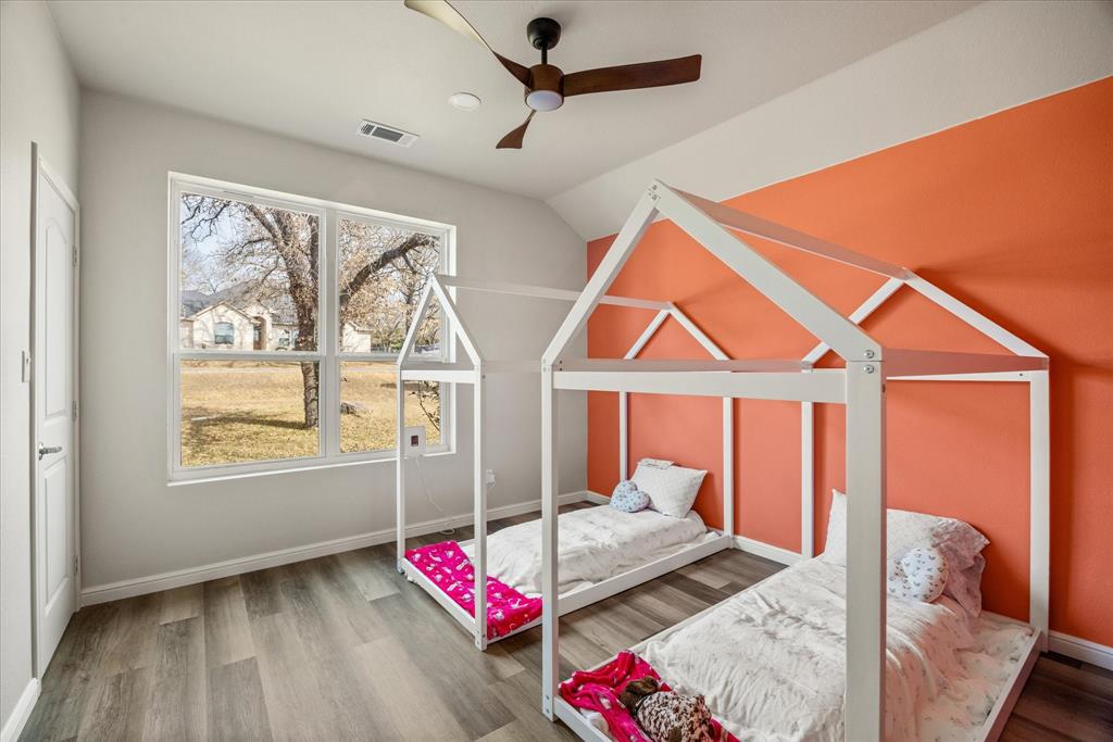4801 West Wedgefield Road Granbury, TX 76049 - Photo 25 of 40 a bedroom with furniture and a window
