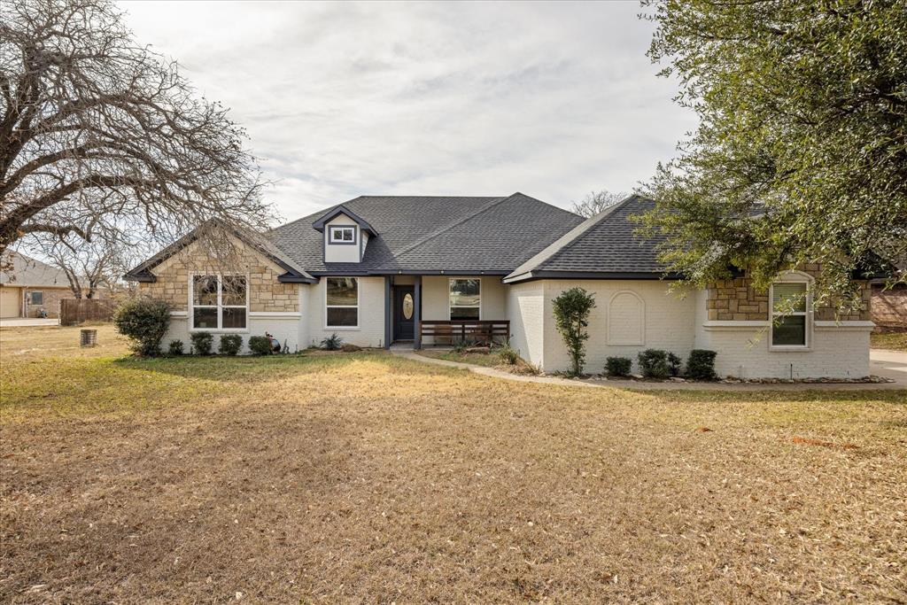 4801 West Wedgefield Road Granbury, TX 76049 - Photo 29 of 40 a front view of a house with a yard and garage