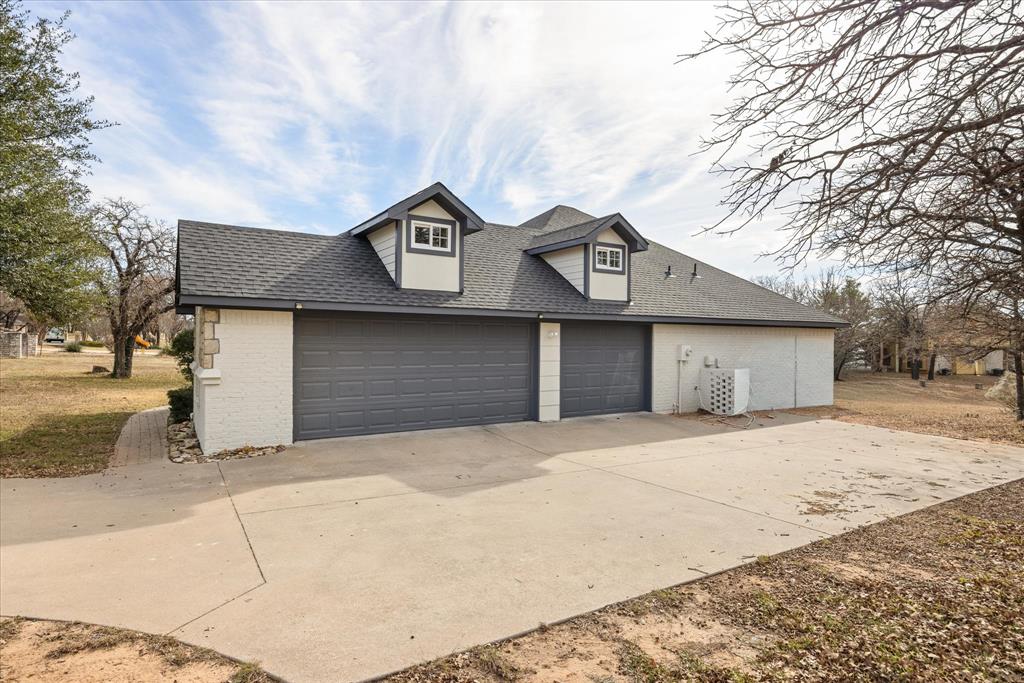4801 West Wedgefield Road Granbury, TX 76049 - Photo 33 of 40 a front view of a house with a yard and garage