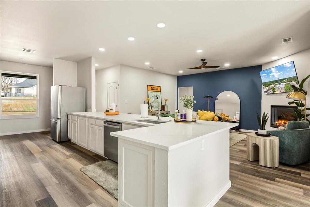 4801 West Wedgefield Road Granbury, TX 76049 - Photo 9 of 40 a kitchen with sink refrigerator and stove