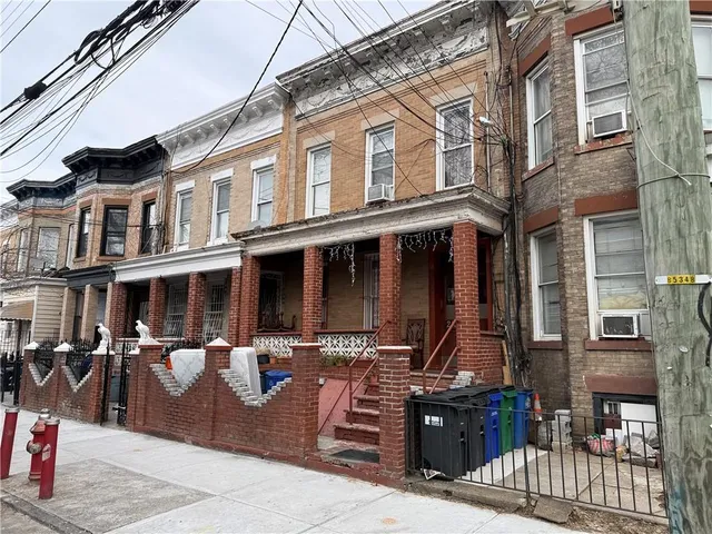 a front view of a brick building with many windows