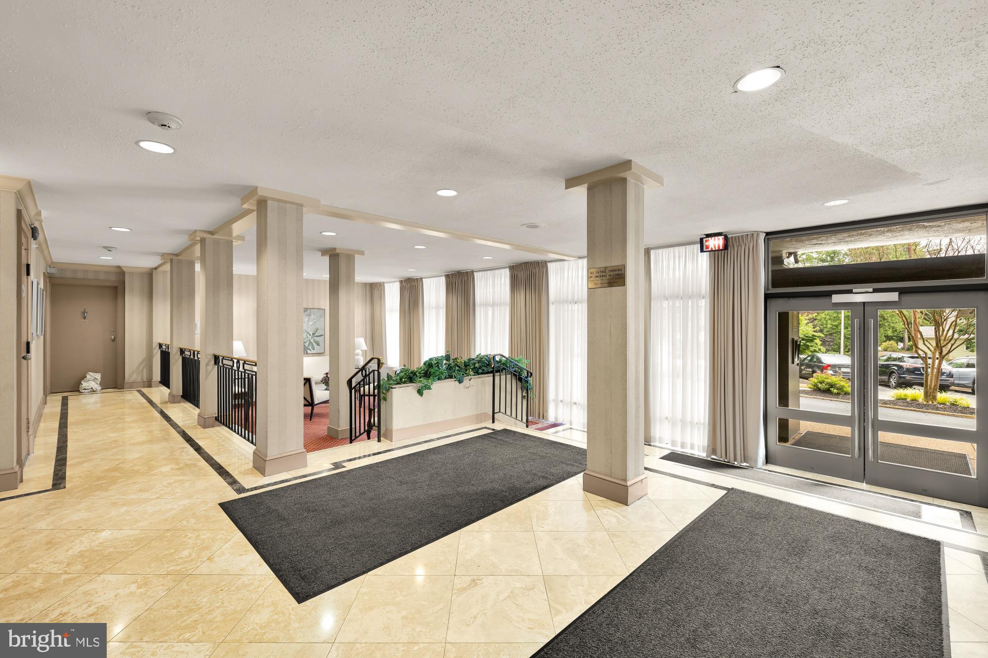 4390 Lorcom Lane, Unit 503 Arlington, VA 22207 - Photo 29 of 31 Elegant lobby with natural light and greenery.