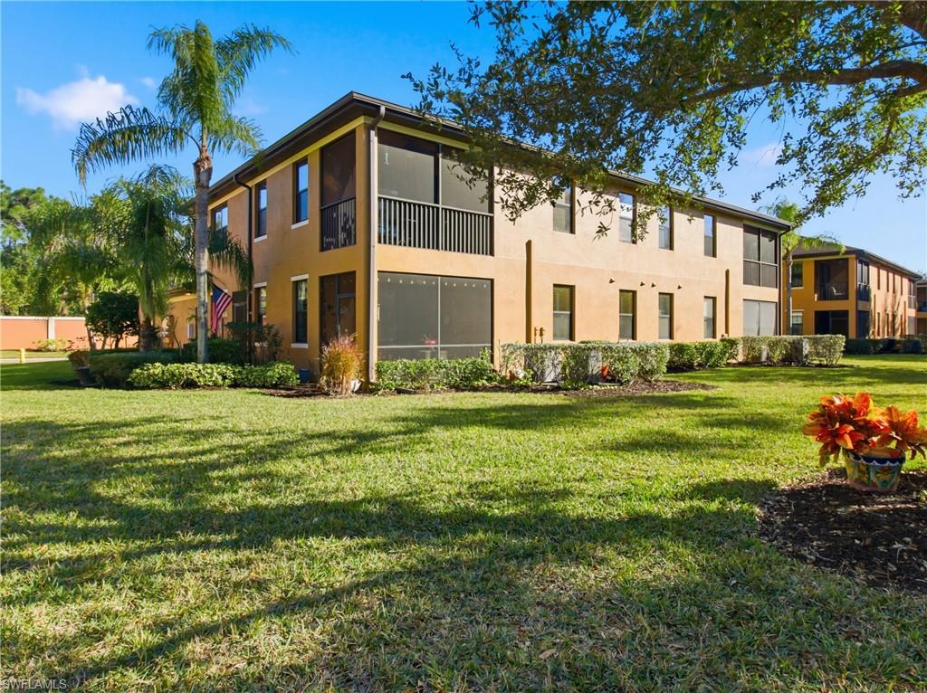 20161 Bravada Street, Unit 2 Estero, FL 33928 - Photo 24 of 33 a front view of a house with a yard table and chairs