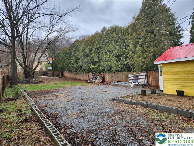 a view of a backyard with large trees