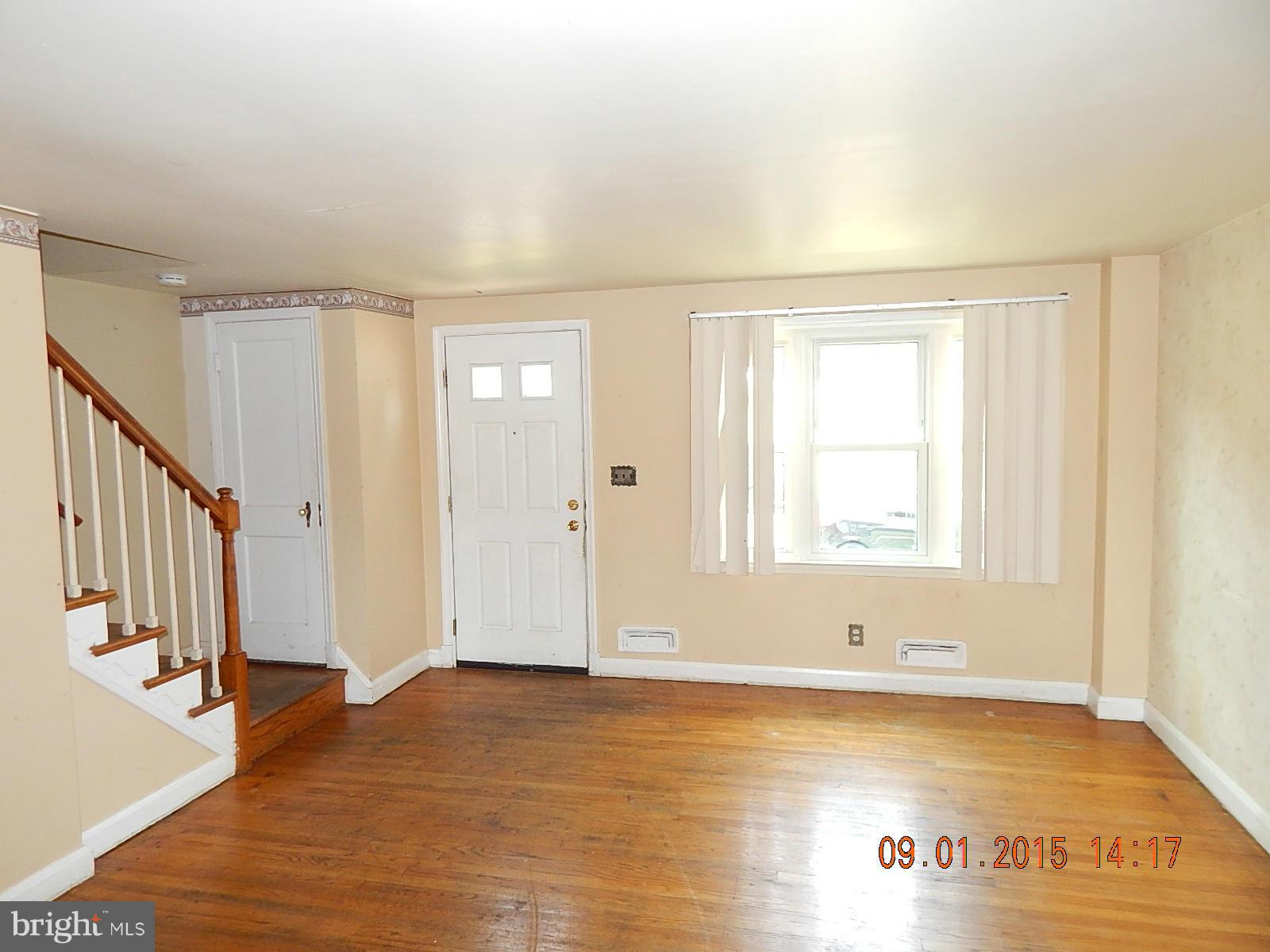 1655 Langford Road Baltimore, MD 21207 - Photo 2 of 12 a view of an empty room with wooden floor and a window