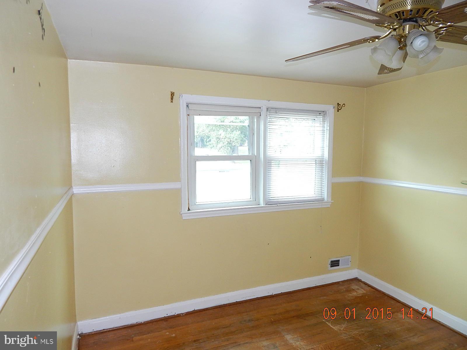1655 Langford Road Baltimore, MD 21207 - Photo 5 of 12 wooden floor in an empty room with a window
