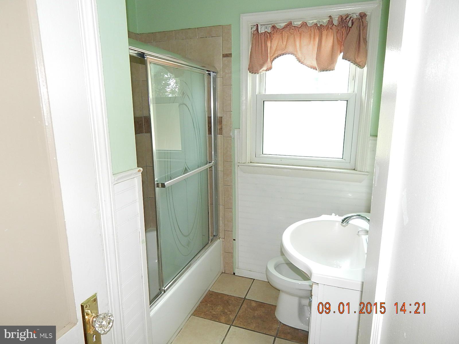 1655 Langford Road Baltimore, MD 21207 - Photo 7 of 12 a bathroom with a sink and a mirror