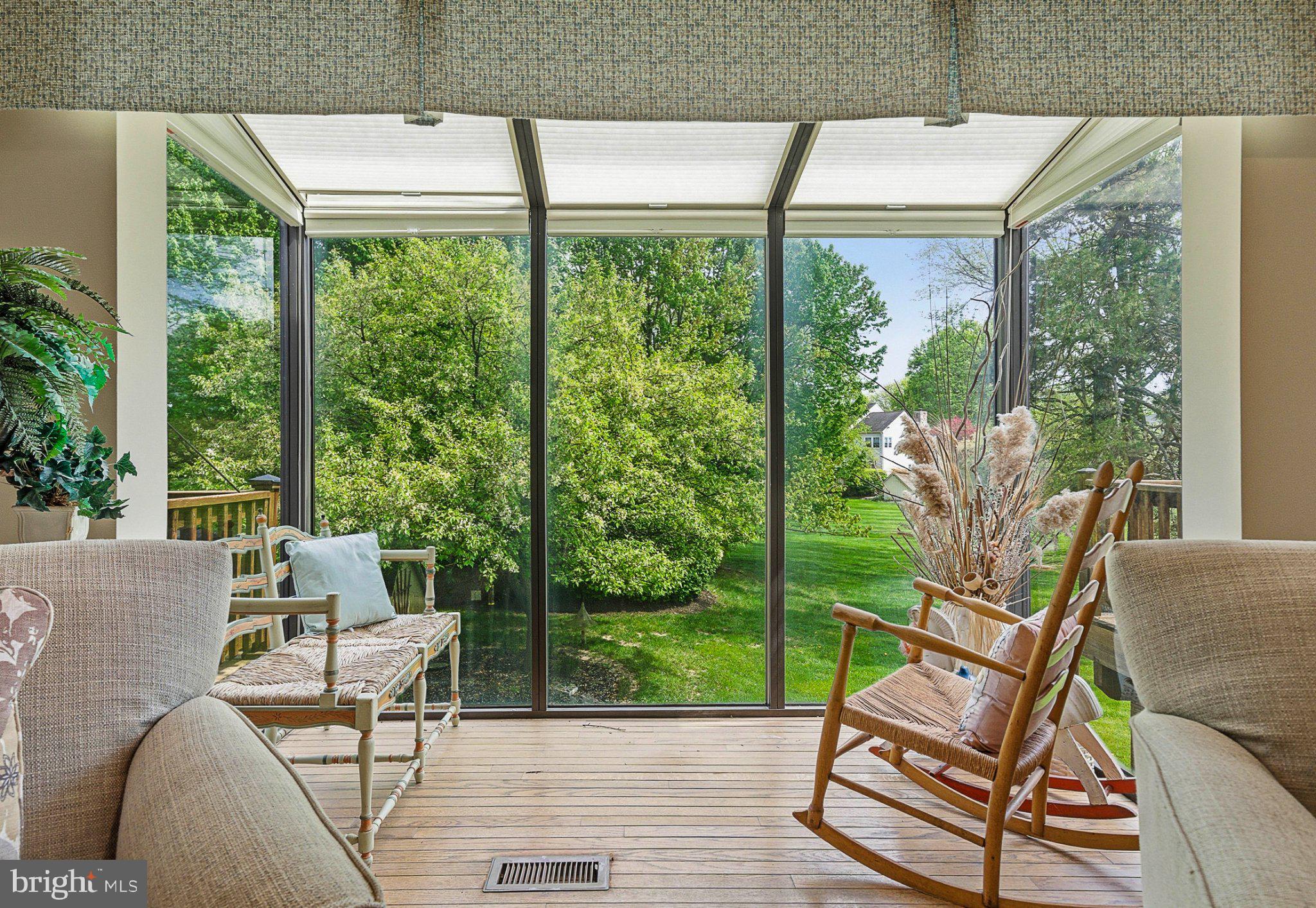 1833 Perrin Court Ambler, PA 19002 - Photo 17 of 58 Serene sunroom with lush green views.