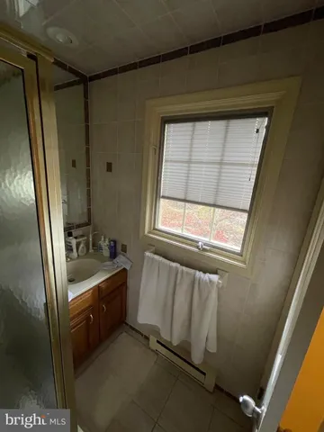 a bathroom with a tub a sink and a window