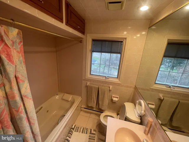 a bath room with a bath tub and a shower