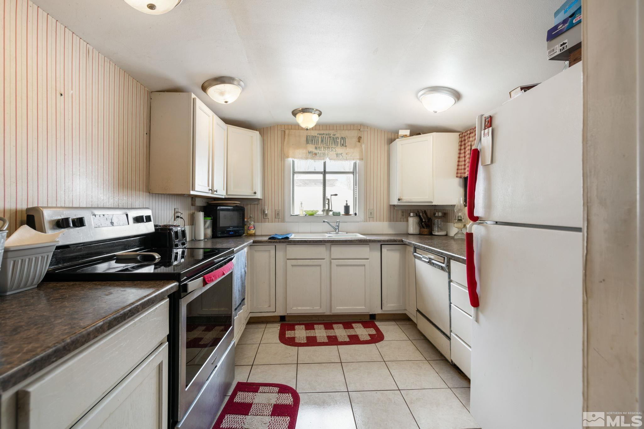 200 Reservation Road Wadsworth, NV 89442 - Photo 11 of 30 a kitchen with a sink cabinets stainless steel appliances and a window