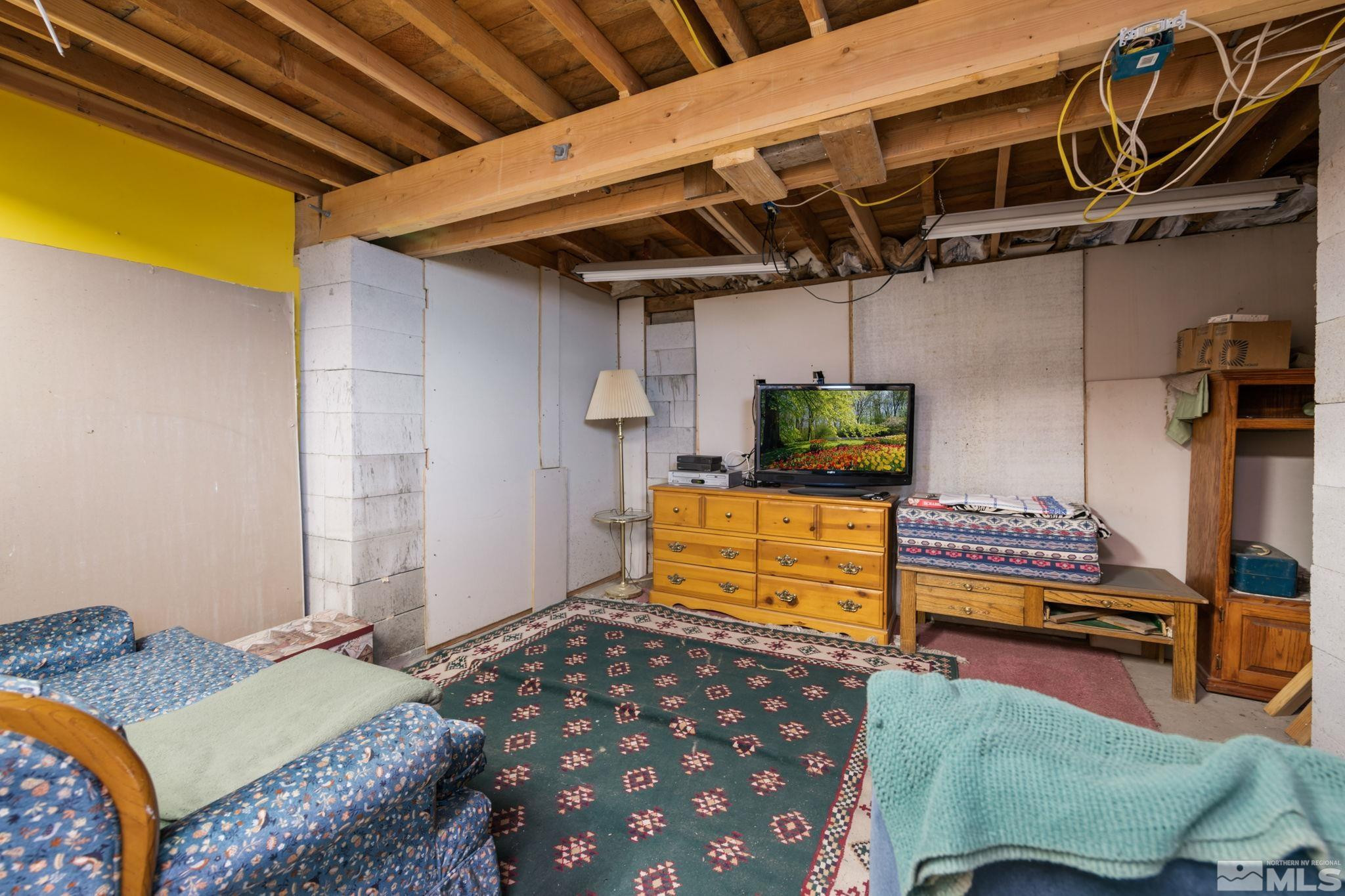 200 Reservation Road Wadsworth, NV 89442 - Photo 13 of 30 a bedroom with a bed and wooden floor