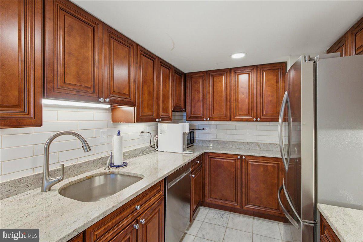 700 7th Street Southwest, Unit 827 Washington, DC 20024 - Photo 22 of 32 Elegant kitchen with rich wood cabinetry.