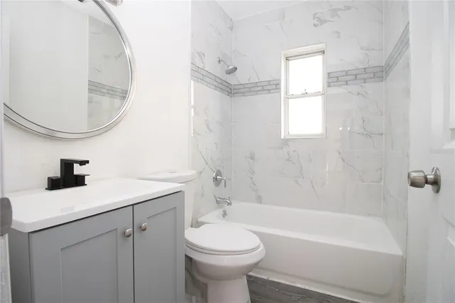 a bathroom with a sink a toilet and bathtub