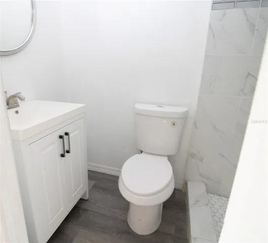 a bathroom with a toilet and a shower