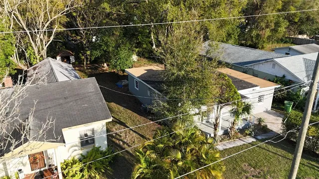 a view of a house with a tree in front of it