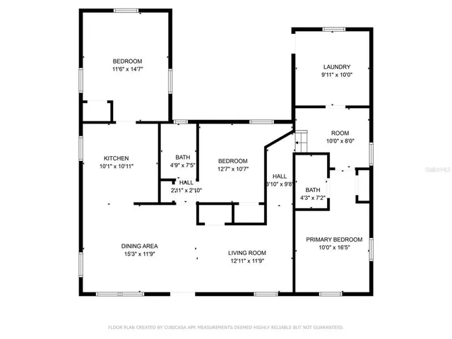 a view of a hallway with wooden floor and a bathroom