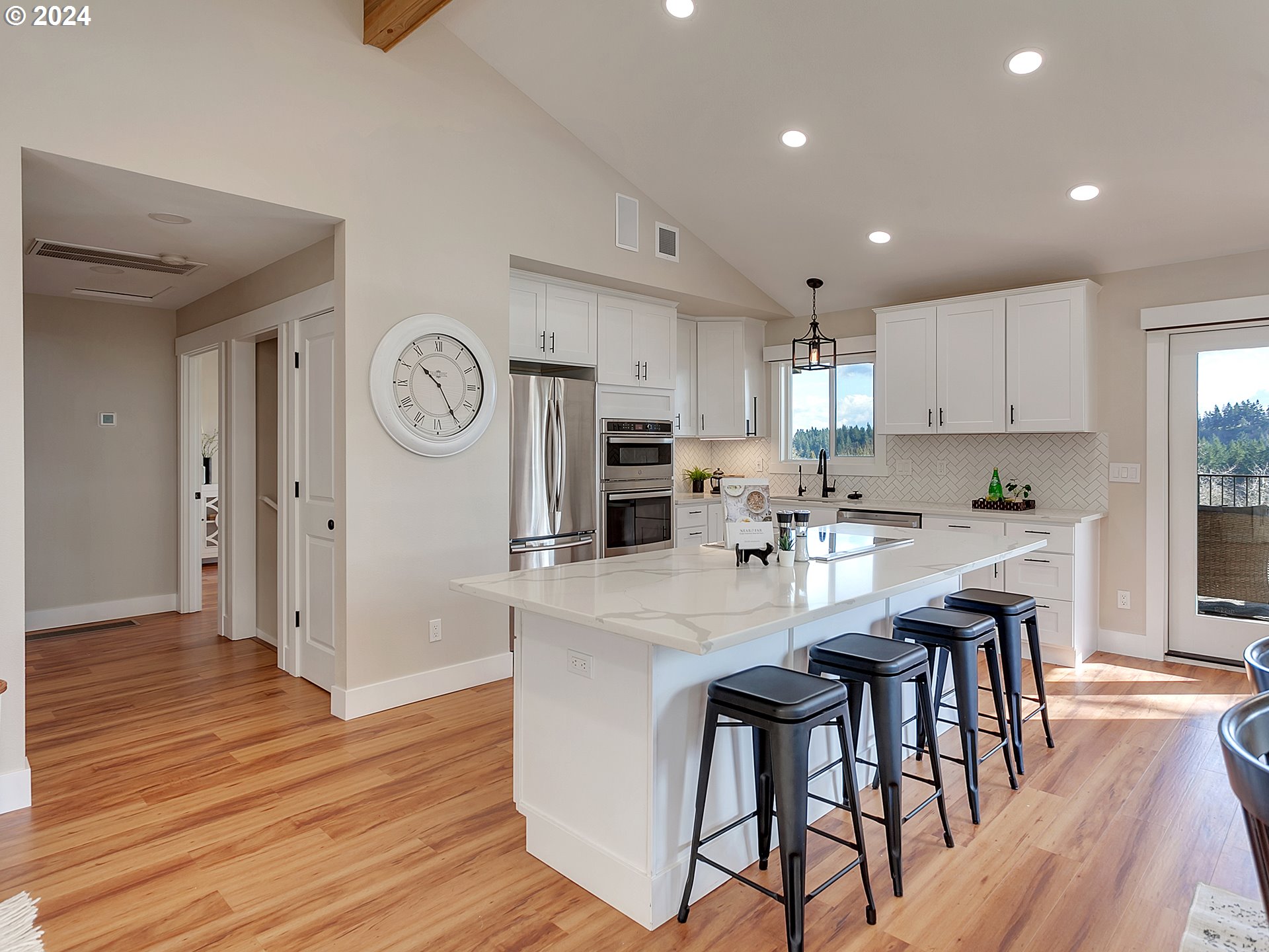 29450 Southwest Ladd Hill Road Sherwood, OR 97140 - Photo 8 of 48 a kitchen with stainless steel appliances granite countertop a table chairs refrigerator a stove a sink and a microwave