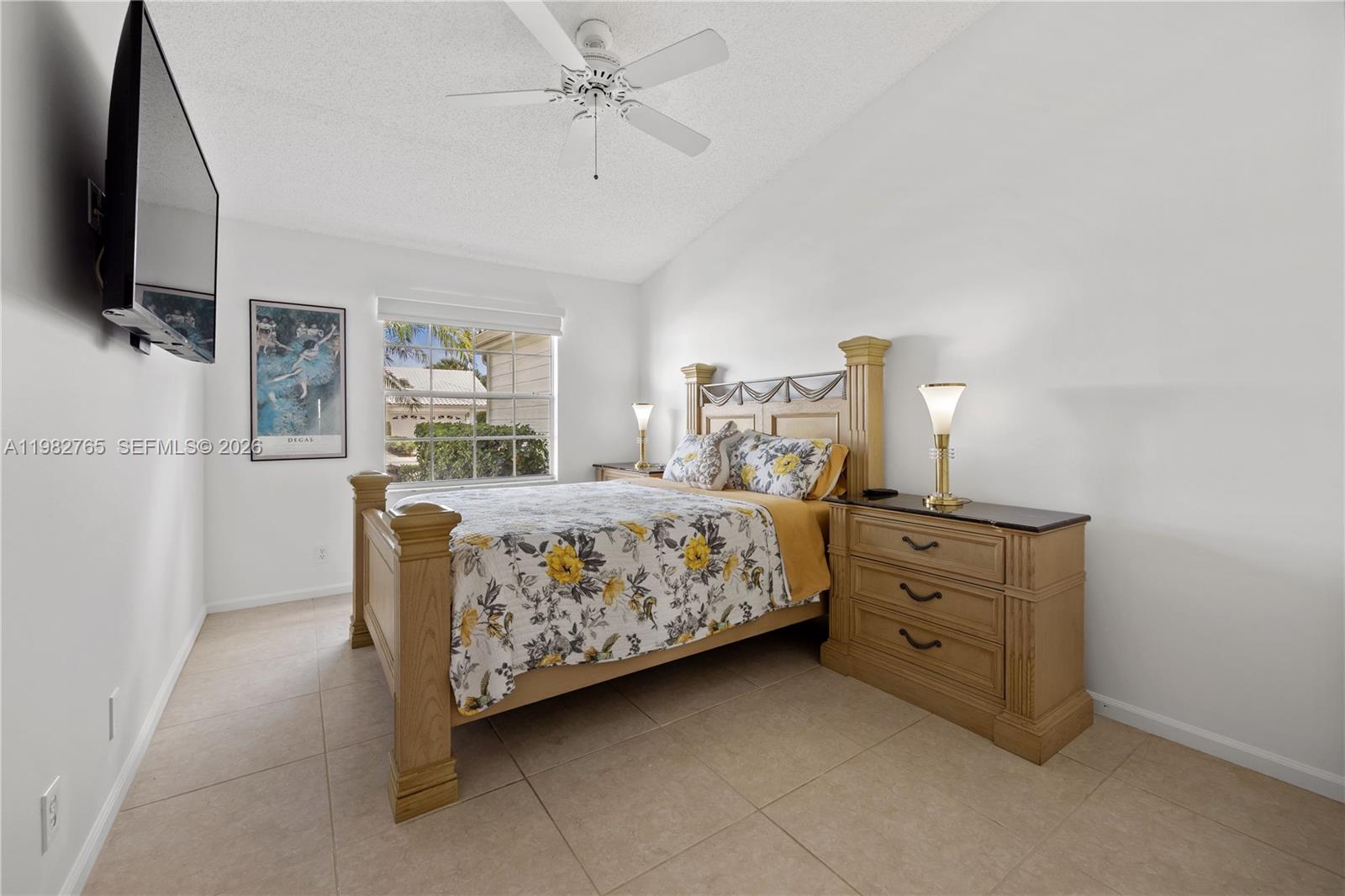 8962 Southeast Riverfront Terrace Jupiter, FL 33469 - Photo 10 of 20 a bedroom with a bed and a flat tv screen on dresser
