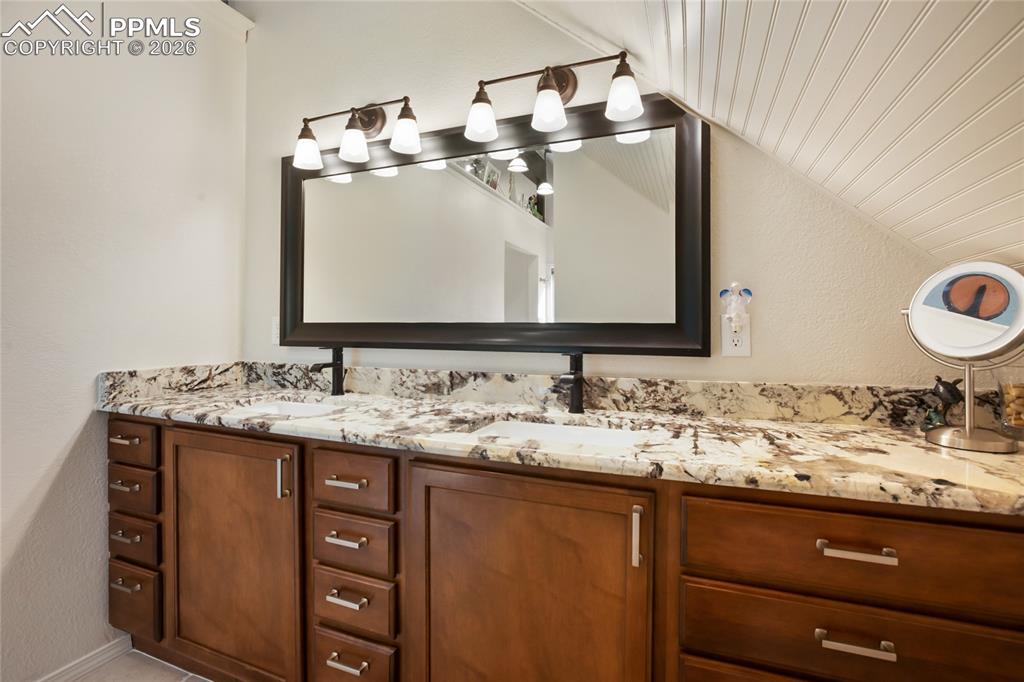 45 Barr Lake Circle Divide, CO 80814 - Photo 19 of 40 a bathroom with a granite countertop sink and a mirror