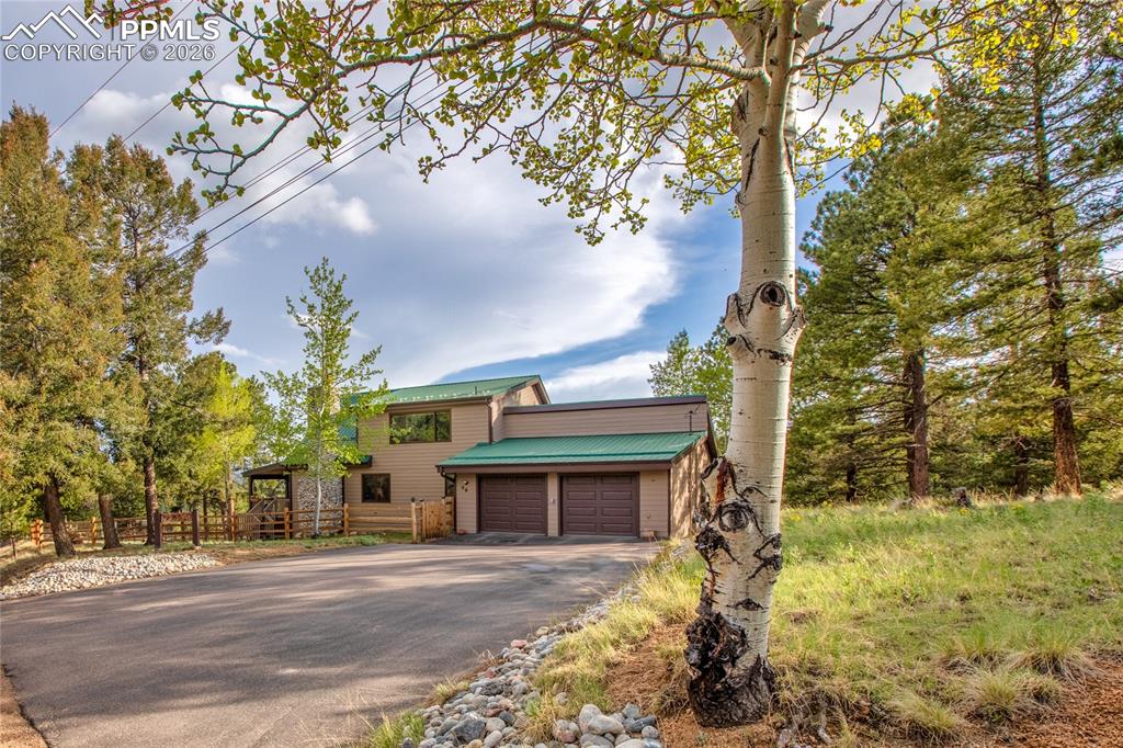 45 Barr Lake Circle Divide, CO 80814 - Photo 2 of 40 a front view of a house with a yard and garage