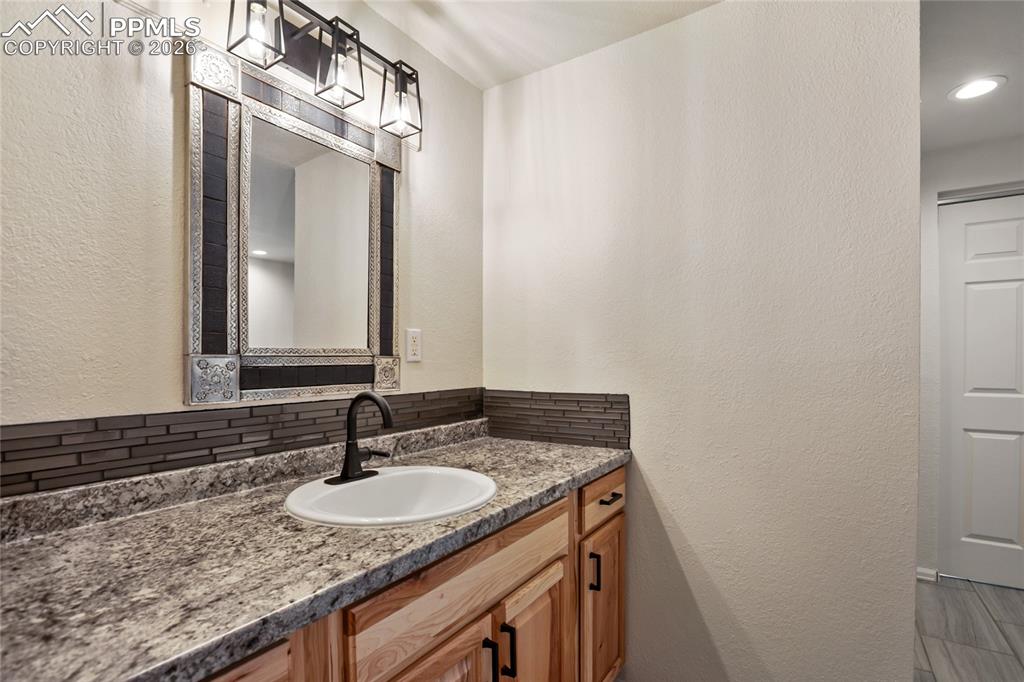 45 Barr Lake Circle Divide, CO 80814 - Photo 30 of 40 a bathroom with a granite countertop sink and a mirror