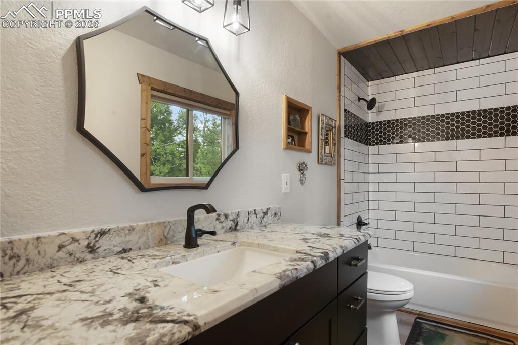 45 Barr Lake Circle Divide, CO 80814 - Photo 3 of 40 a bathroom with a granite countertop sink toilet and mirror