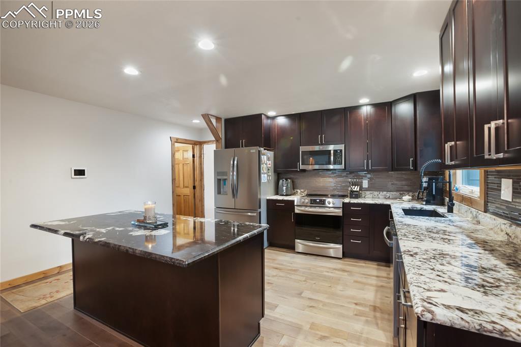 45 Barr Lake Circle Divide, CO 80814 - Photo 4 of 40 a kitchen with stainless steel appliances granite countertop a sink counter space and cabinets