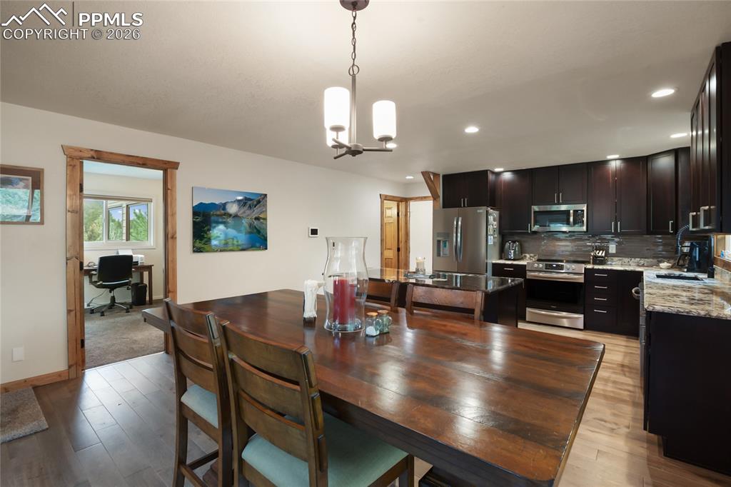 45 Barr Lake Circle Divide, CO 80814 - Photo 7 of 40 a view of a dining room with furniture a chandelier and wooden floor