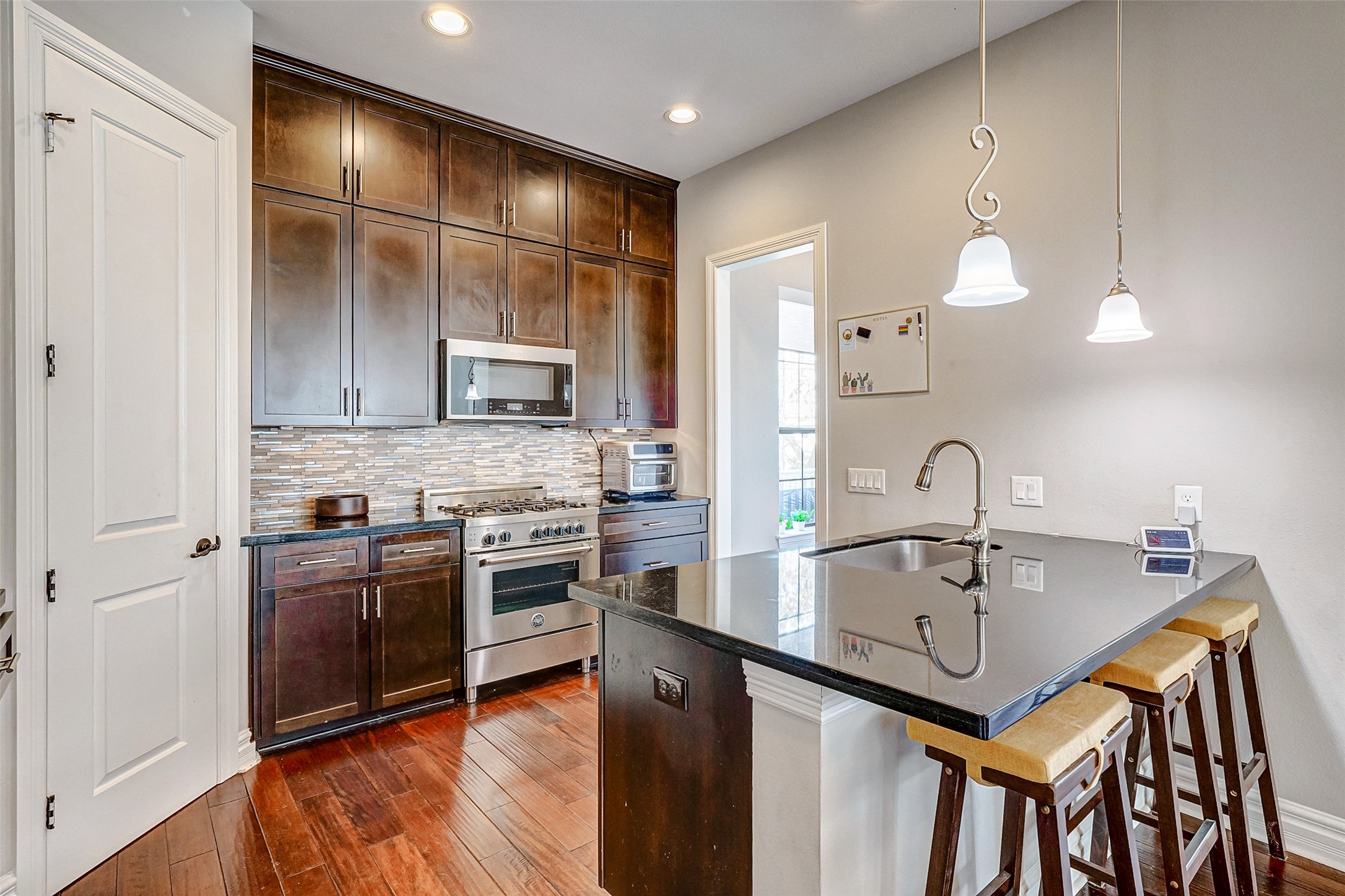 1237 West 24th Street Houston, TX 77008 - Photo 3 of 35 a kitchen with kitchen island granite countertop a sink cabinets and stainless steel appliances