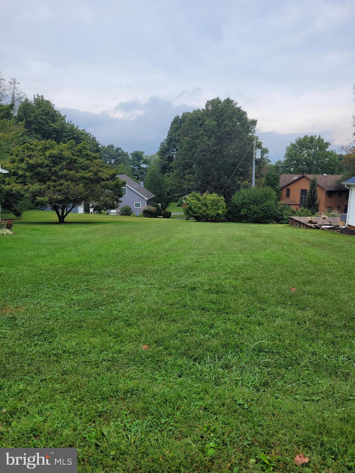 a view of a big yard with a house in the background