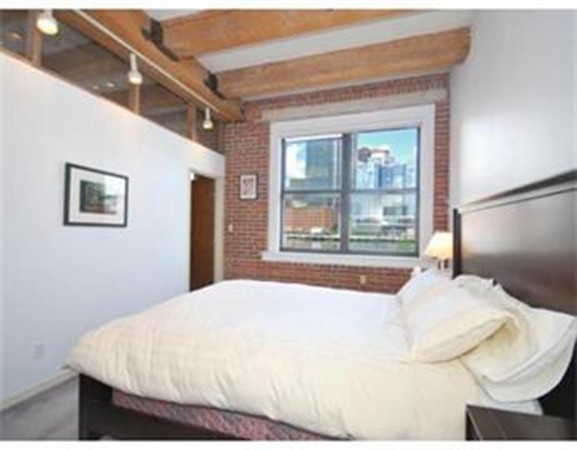 33 Sleeper Street, Unit 204 Boston, MA 02210 - Photo 4 of 4 a bedroom with a large bed and a large window