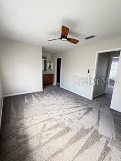 11019 Yorkshire Ridge Court Orlando, FL 32837 - Photo 11 of 15 a view of a livingroom with wooden floor and ceiling fan